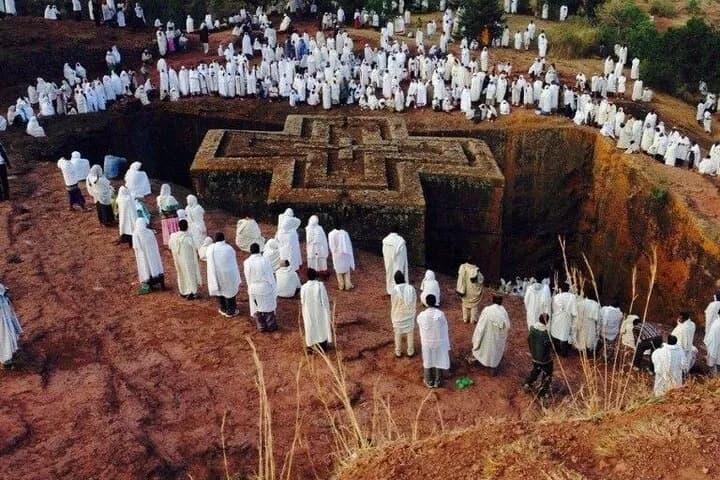 Priest with ancient cross